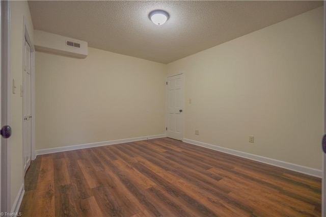 804 W 4th Ave, Lexington, NC 27292 - spare room featuring baseboards, dark wood-style flooring, a textured ceiling, and visible vents