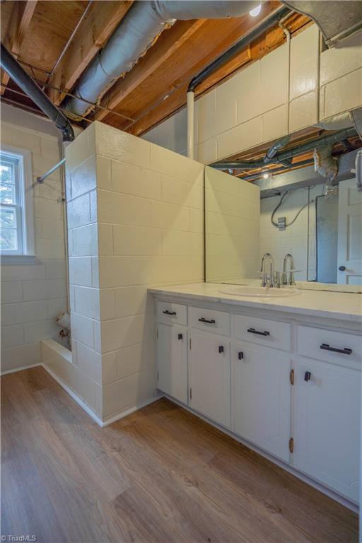 804 W 4th Ave, Lexington, NC 27292 - interior space with concrete block wall, a sink, and light wood finished floors