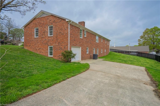 804 W 4th Ave, Lexington, NC 27292 - view of side of home with driveway, a chimney, brick siding, a garage, and a yard