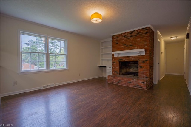 804 W 4th Ave, Lexington, NC 27292 - unfurnished living room featuring crown molding, dark wood-style flooring, baseboards, visible vents, and a brick fireplace