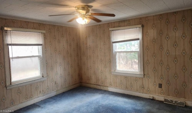 empty room featuring dark colored carpet and ceiling fan