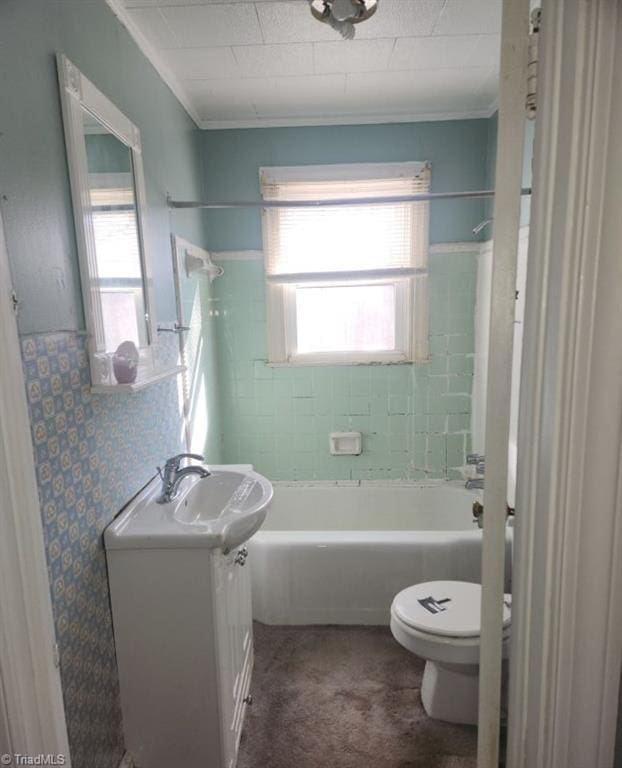 full bathroom featuring vanity, toilet, tiled shower / bath combo, and crown molding