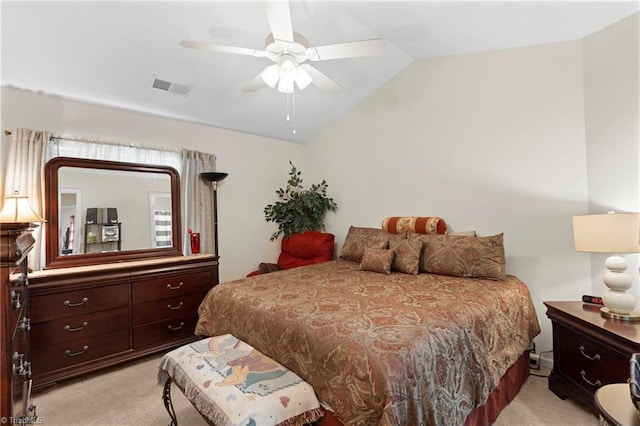 bedroom with visible vents, light colored carpet, lofted ceiling, and ceiling fan