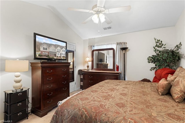 bedroom featuring a ceiling fan, lofted ceiling, light colored carpet, and visible vents