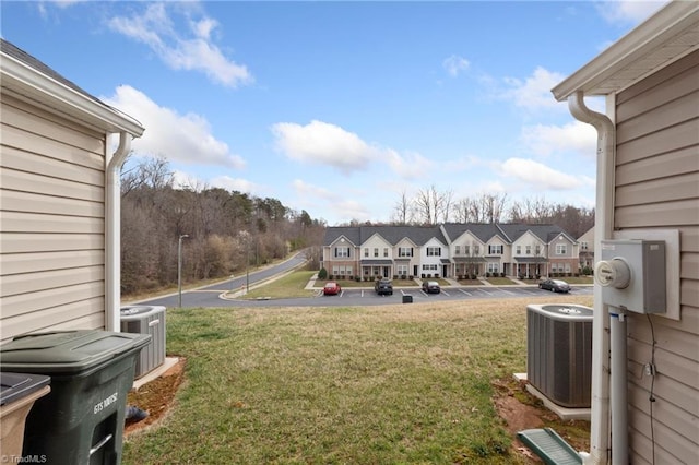 view of yard with a residential view and central AC