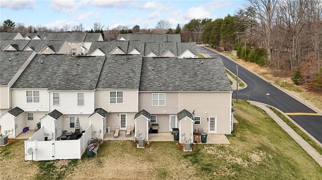 rear view of house with a patio, fence, central AC unit, and a gate