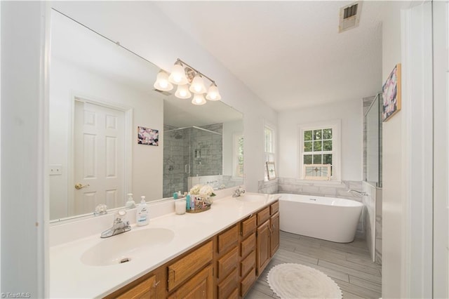 1923 Treyburn Ln, High Point, NC 27265 - full bath featuring a shower stall, a freestanding bath, double vanity, and wood finished floors