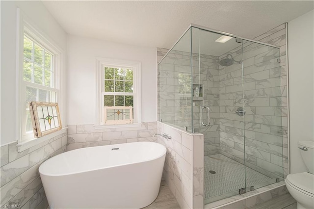 1923 Treyburn Ln, High Point, NC 27265 - full bathroom with tile walls, healthy amount of natural light, a soaking tub, wainscoting, and a shower stall