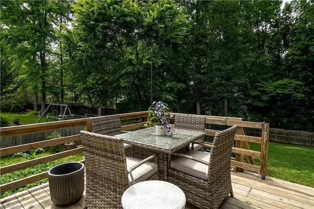 1923 Treyburn Ln, High Point, NC 27265 - deck with outdoor dining area, a fenced backyard, and a playground