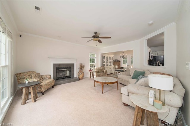 1923 Treyburn Ln, High Point, NC 27265 - carpeted living area with ornamental molding, ceiling fan, a chandelier, and a tiled fireplace