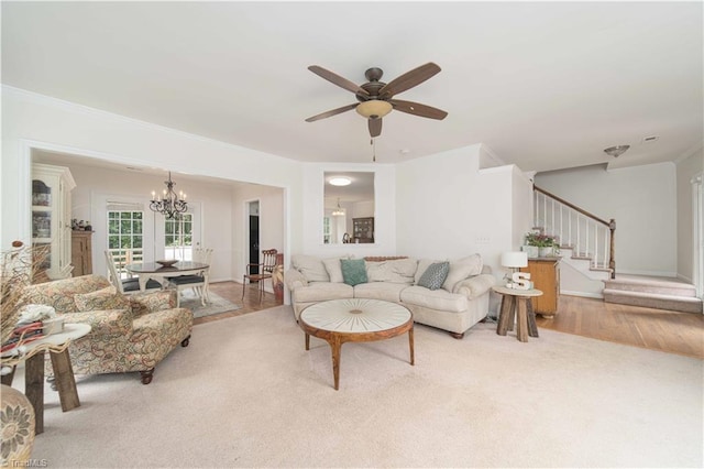 1923 Treyburn Ln, High Point, NC 27265 - carpeted living room with stairs, a chandelier, ceiling fan, and ornamental molding