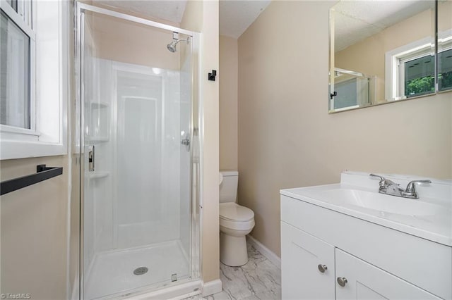 full bathroom featuring a shower stall, toilet, marble look tiles, baseboards, and vanity