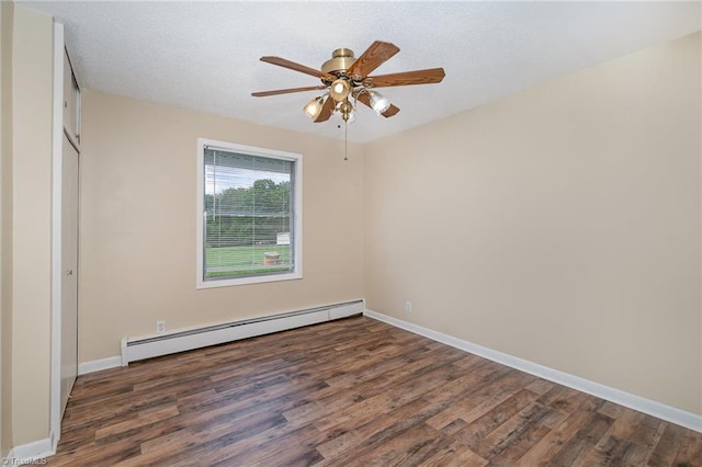 unfurnished bedroom featuring a baseboard heating unit, wood finished floors, and baseboards