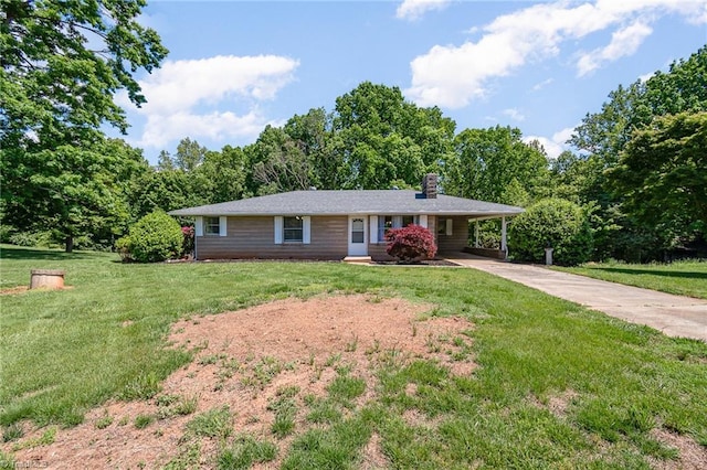 ranch-style house with concrete driveway, a chimney, a carport, and a front lawn