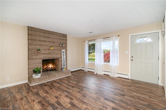 unfurnished living room featuring wood finished floors, a fireplace, baseboards, and a baseboard radiator