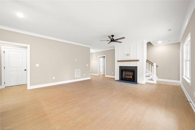 6957 Orchard Path Dr, Clemmons, NC 27012 - unfurnished living room with ceiling fan, light wood-style flooring, crown molding, baseboards, and a fireplace