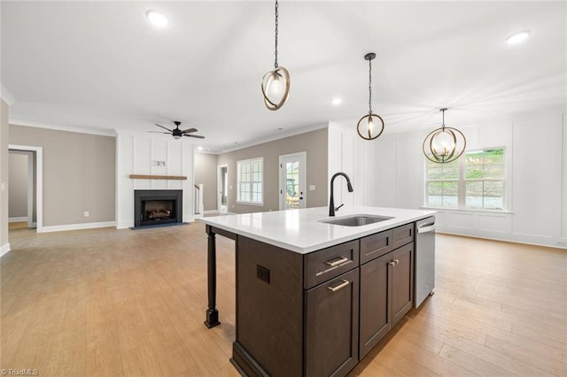 6957 Orchard Path Dr, Clemmons, NC 27012 - kitchen with dishwasher, a sink, ceiling fan, a large fireplace, and dark brown cabinetry