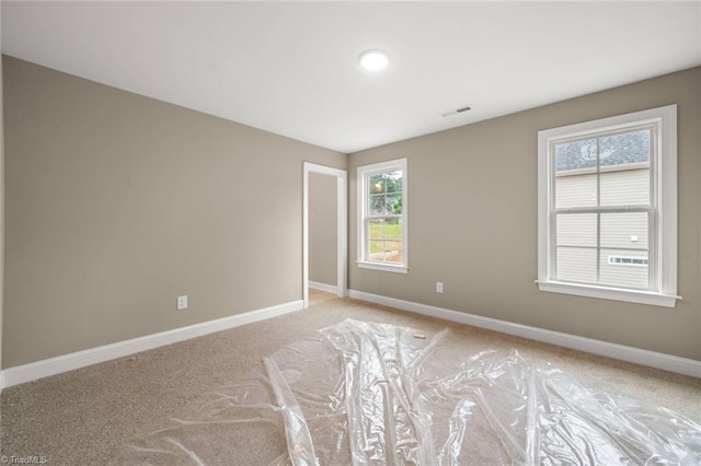 6957 Orchard Path Dr, Clemmons, NC 27012 - spare room featuring baseboards and light colored carpet