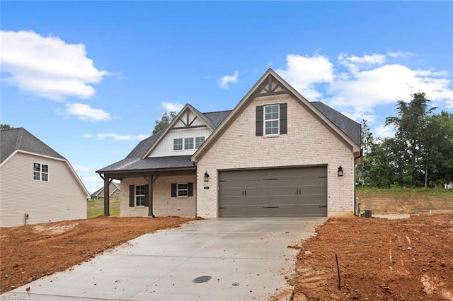 6957 Orchard Path Dr, Clemmons, NC 27012 - view of front of property featuring driveway, brick siding, a garage, and a porch