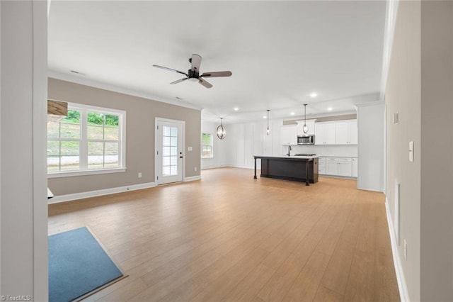 6957 Orchard Path Dr, Clemmons, NC 27012 - unfurnished living room with light wood-type flooring, baseboards, recessed lighting, a ceiling fan, and crown molding
