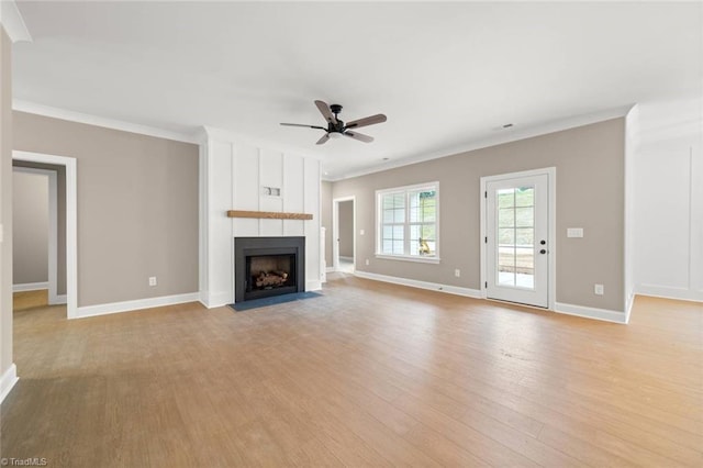 6957 Orchard Path Dr, Clemmons, NC 27012 - unfurnished living room with crown molding, light wood finished floors, ceiling fan, baseboards, and a large fireplace