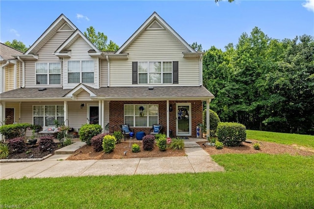 2 Tannenbaum Cir, Greensboro, NC 27410 - view of property featuring a front lawn, covered porch, and brick siding