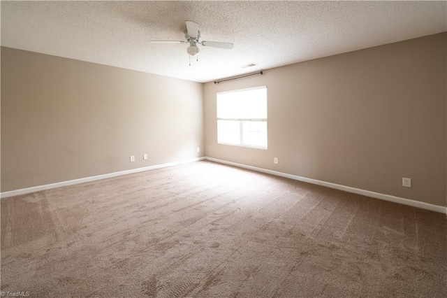 carpeted empty room featuring a textured ceiling and ceiling fan