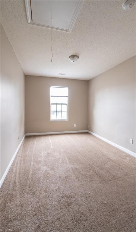 carpeted spare room featuring a textured ceiling