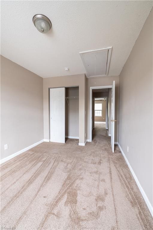 unfurnished bedroom with a closet and light carpet