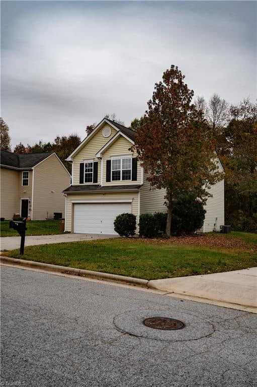 view of front of home featuring a garage and a front yard