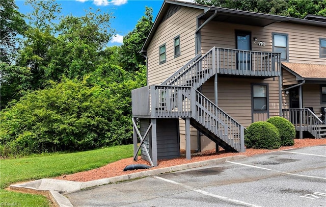 170 Vista Cir Unit C, Winston-Salem, NC 27106 - view of home's exterior featuring stairway, uncovered parking, and a yard