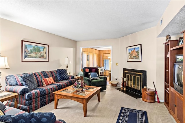carpeted living area with a textured ceiling and a fireplace with flush hearth