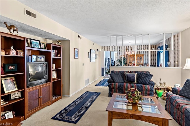 living room featuring track lighting, carpet flooring, and a textured ceiling