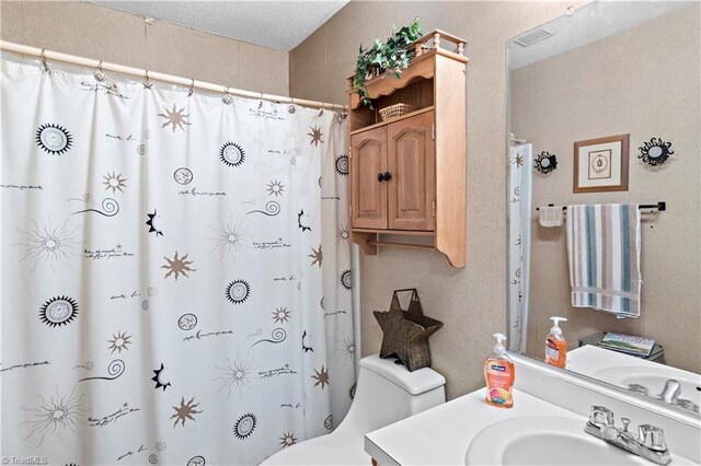 full bathroom with vanity, toilet, and a shower with shower curtain
