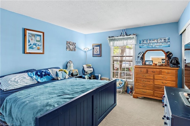 bedroom featuring light colored carpet and a textured ceiling