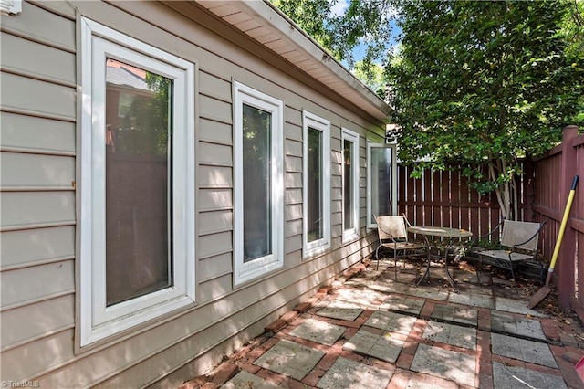 view of side of property featuring a patio and fence
