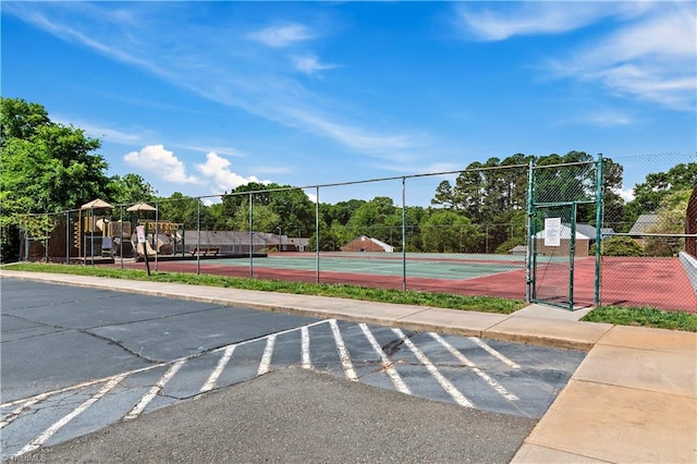 view of tennis court with fence and a gate
