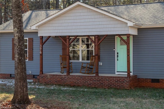 bungalow-style home with a front yard and covered porch