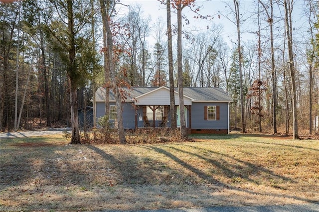 ranch-style home with covered porch and a front yard