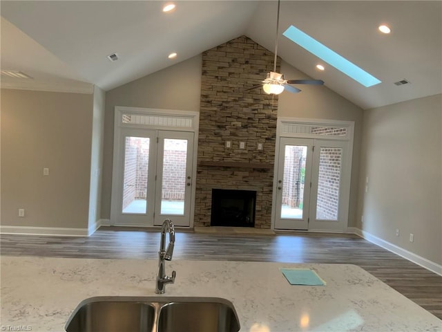 kitchen with a wealth of natural light, visible vents, a sink, and wood finished floors