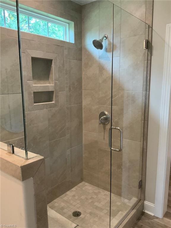 full bath with a shower stall