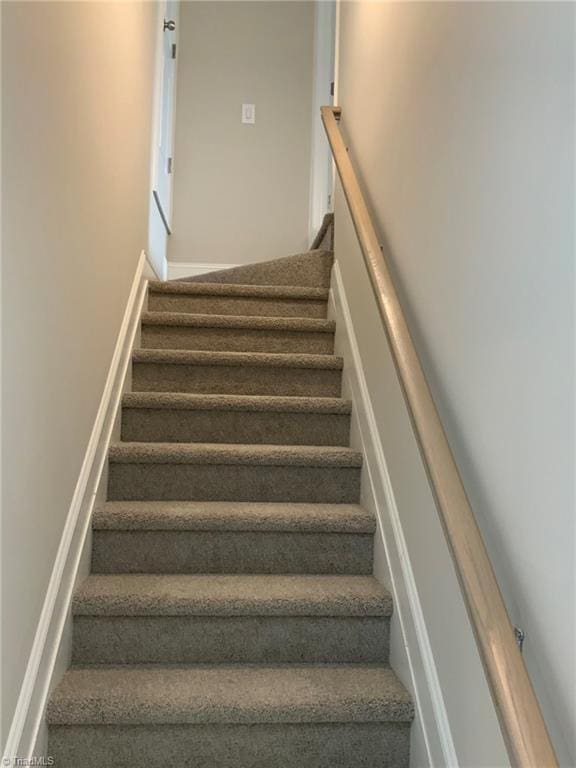 staircase featuring baseboards