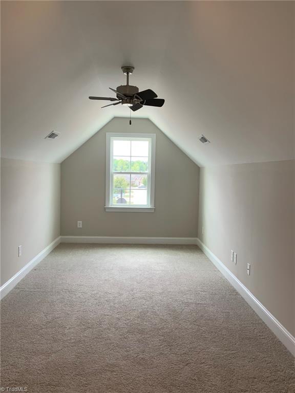 bonus room featuring vaulted ceiling, visible vents, and baseboards