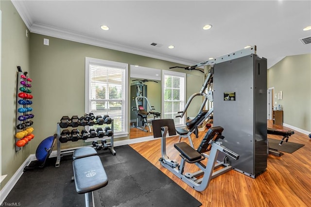 exercise area featuring recessed lighting, wood finished floors, visible vents, baseboards, and ornamental molding