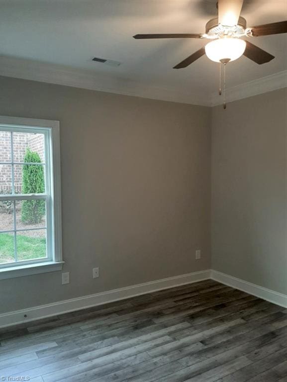 unfurnished room featuring visible vents, baseboards, ceiling fan, wood finished floors, and crown molding