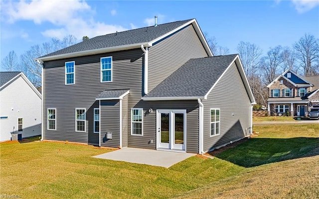 rear view of house with a patio area and a yard