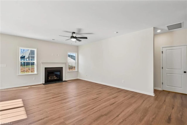 unfurnished living room with ceiling fan and light hardwood / wood-style flooring