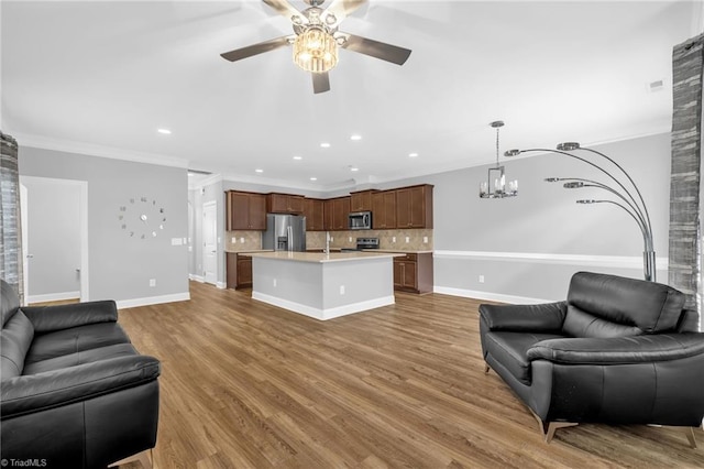 1604 Sunny Hill Way, Colfax, NC 27235 - living room featuring ceiling fan, ornamental molding, a chandelier, wood finished floors, and recessed lighting