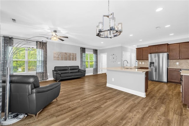 1604 Sunny Hill Way, Colfax, NC 27235 - kitchen with stainless steel fridge, a chandelier, crown molding, light countertops, and a sink
