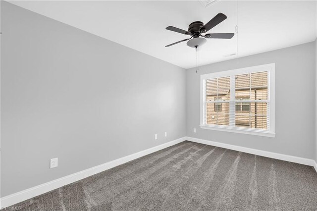 1604 Sunny Hill Way, Colfax, NC 27235 - spare room featuring attic access, baseboards, dark carpet, and a ceiling fan